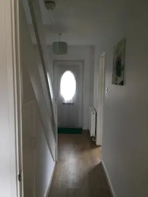 a hallway with a round window in a room at 4 Bed House next to Basildon Town Centre in Basildon