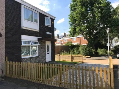 a house with a wooden fence in front of it at 4 Bed House next to Basildon Town Centre in Basildon