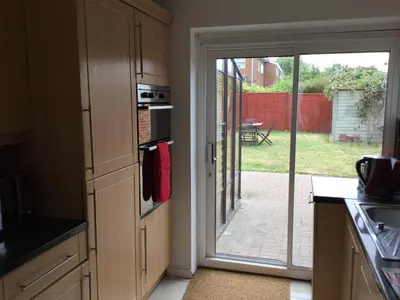 a kitchen with an open door to a patio at 4 Bed House next to Basildon Town Centre in Basildon
