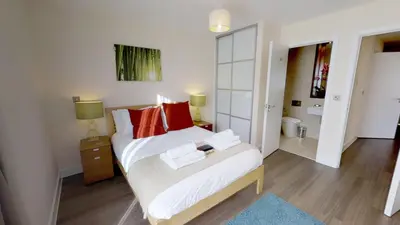 a bedroom with two beds with red pillows at Signet Apartments - Ceres in Cambridge