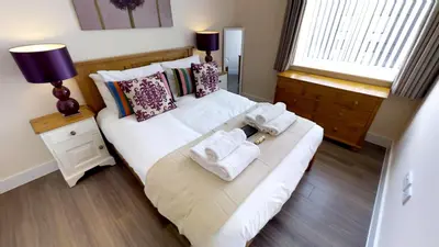 a bedroom with two beds with towels on them at Signet Apartments - Ceres in Cambridge