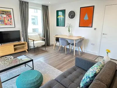a living room with a couch and a table at Signet Apartments - Ceres in Cambridge