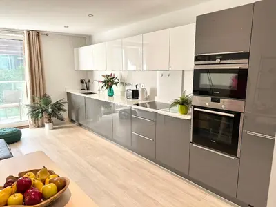 a kitchen with stainless steel appliances and a bowl of fruit at Signet Apartments - Vesta in Cambridge