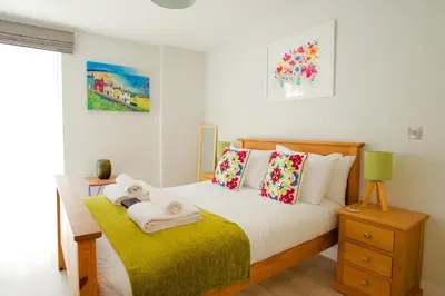 a bedroom with a bed with towels on it at Signet Apartments - Vesta in Cambridge