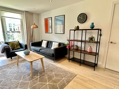 a living room with a couch and a table at Signet Apartments - Vesta in Cambridge