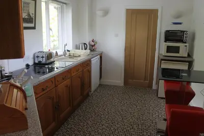 a kitchen with a sink and a microwave at Pear Tree House Studio in Ely
