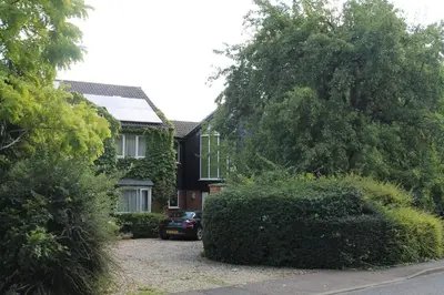 a house with a car parked in front of it at Pear Tree House Studio in Ely