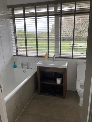 a bathroom with a tub and a sink and a toilet at Private luxury retreat in Sible Hedingham