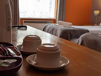 a wooden table with two cups on top of it at The Earl Of Derby in Cambridge