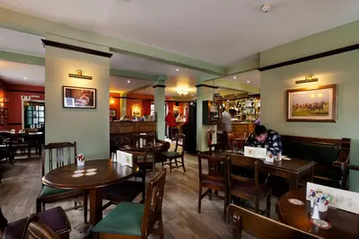 a person sitting at a table in a restaurant at The Earl Of Derby in Cambridge