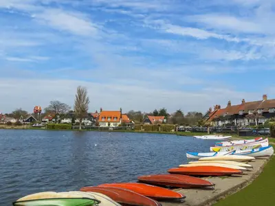 a row of boats lined up on the water at 2 Suffolk Cottage, Knodishall - Aldeburgh Coastal Cottages in Aldringham