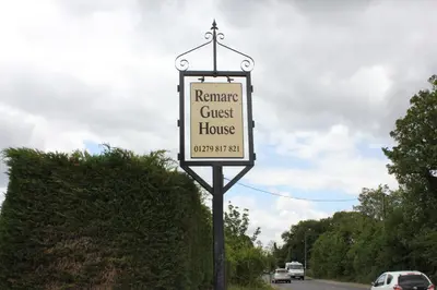 a sign for a guest house on a street at Remarc Guest House in Takeley