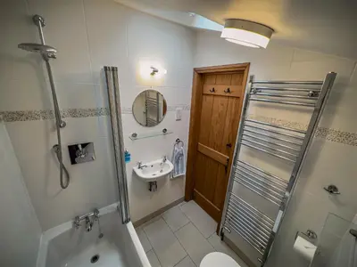 a bathroom with a shower toilet and a sink at All Seasons Cottage Breaks in Saxmundham