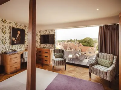 a bedroom with a large window with a view at The Varsity Hotel & Spa in Cambridge