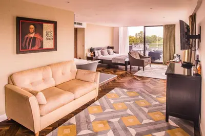 a living room with a brown couch and a living room at The Varsity Hotel & Spa in Cambridge
