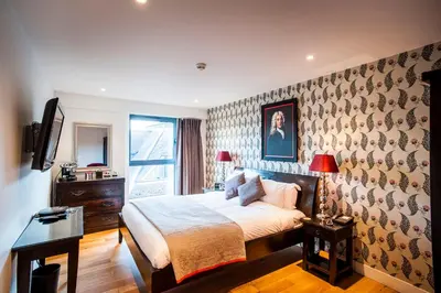 a bedroom with a bed and a wall at The Varsity Hotel & Spa in Cambridge