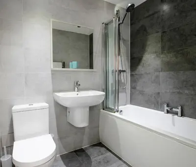 a bathroom with a toilet and a sink and a bath tub at Airport Reach in Southend-on-Sea