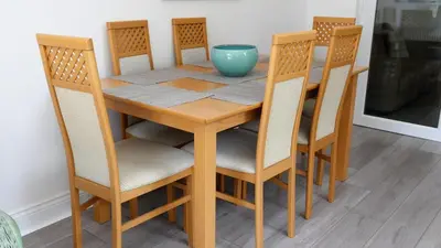 a wooden table with chairs and a blue bowl on it at Airport Reach in Southend-on-Sea