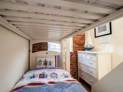 a bedroom with a bed in a small room at Pebble Cottage in Aldeburgh