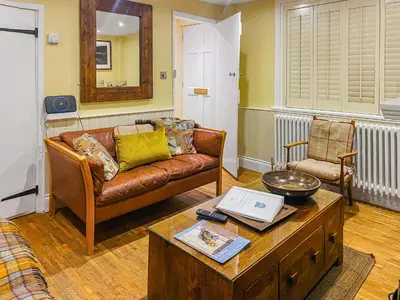 a living room with a couch and a coffee table at Pebble Cottage in Aldeburgh