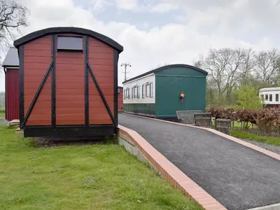 a red and green building on the side of a road at Wilby Halt-Ukc712 in Wetheringsett