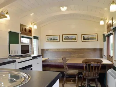 a kitchen with a table and two chairs in it at Wilby Halt-Ukc712 in Wetheringsett