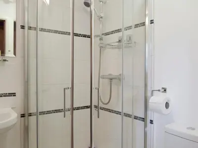 a bathroom with a shower and a toilet and a sink at Wilby Halt-Ukc712 in Wetheringsett