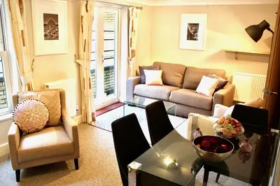 a living room with a couch and a table at Mathus Gardens in Cambridge