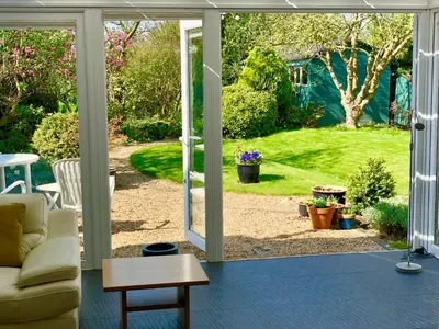a living room with an open door to a yard at Laurels in Felsted