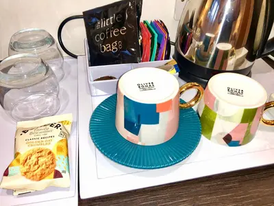 two coffee mugs sitting on a counter next to a coffee pot at Laurels in Felsted