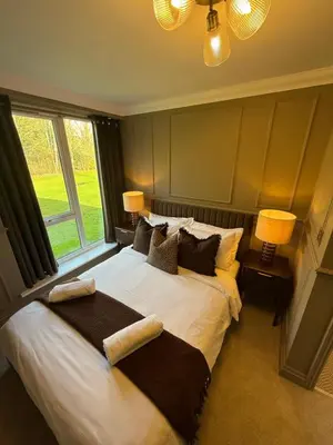 a bedroom with a large bed with two pillows at Everglades in Denver