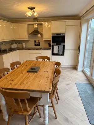 a kitchen and dining room with a wooden table and chairs at Everglades in Denver