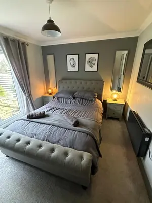 a bedroom with a large bed with a large window at Everglades in Denver