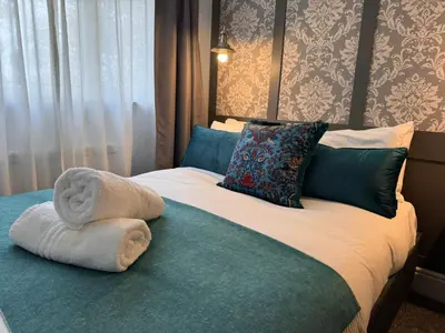 a bedroom with a bed with a towel on it at Regency House in Cambridge
