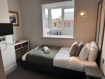 a small bedroom with a bed and a window at Regency House in Cambridge