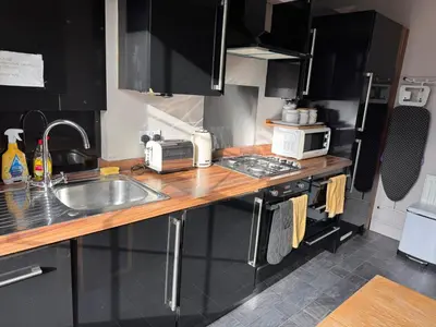 a kitchen with a counter with a sink and a microwave at Regency House in Cambridge