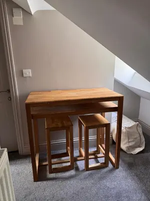 a wooden table and stool in a room at Regency House in Cambridge