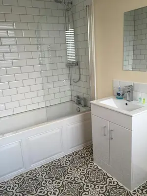 a bathroom with a tub and a sink at The Dorrington in Halstead