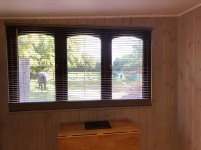 a room with two windows and a wooden table at The Walnuts Country House in West Row