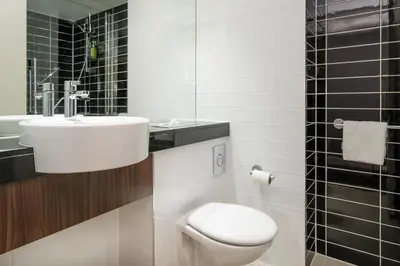 a bathroom with a white toilet and a sink at B&B Hotel Cambridge South in Cambridge