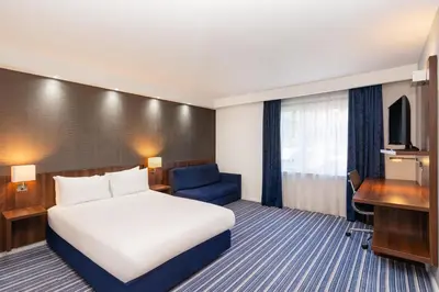 a hotel room with a bed and a desk at B&B Hotel Cambridge South in Cambridge