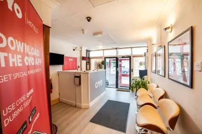 a waiting room with a row of chairs and a counter at Devine Beach Hotel, Westcliff Southend-On-Sea in Southend-on-Sea