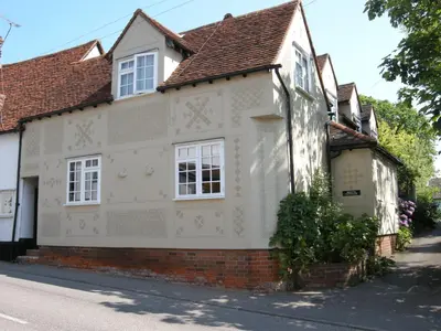 a white house with white windows on a street at Motts Bed & Breakfast in Great Dunmow