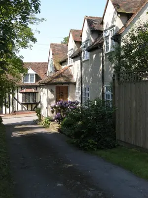 a house with a wooden gate and a fence at Motts Bed & Breakfast in Great Dunmow
