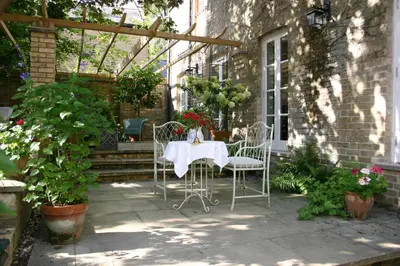 a table and chairs sitting on a patio at The Domek in Ashwell