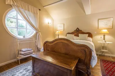 a bedroom with a large bed and a window at The Domek in Ashwell