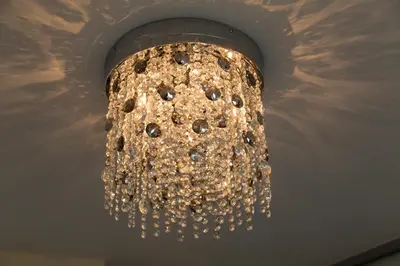 a chandelier hanging from the ceiling of a room at Contemporary & Homely Penthouse, 2 mins walk from Cambridge Station, lift access, secured gated on-site parking, self check-in, SUPER Fast WIFI, Terrace & Sleeps 6 in Cambridge
