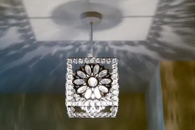 a chandelier is hanging from a ceiling at Contemporary & Homely Penthouse, 2 mins walk from Cambridge Station, lift access, secured gated on-site parking, self check-in, SUPER Fast WIFI, Terrace & Sleeps 6 in Cambridge
