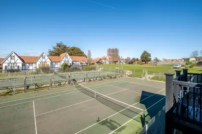 a tennis court in a residential neighborhood at 2 Bell Lodge, Thorpeness in Thorpeness