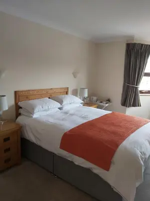 a bedroom with a large bed and a window at Byerley House in Newmarket